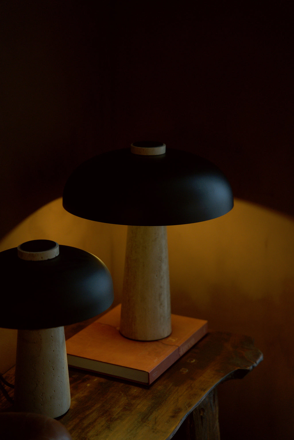 Both sizes of the Corvus lamp together on a console, the 42 cm lit, the 34 cm unlit.